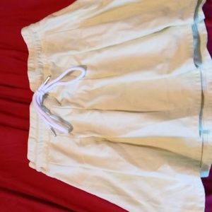 A skirt that is greenish and white bow tie